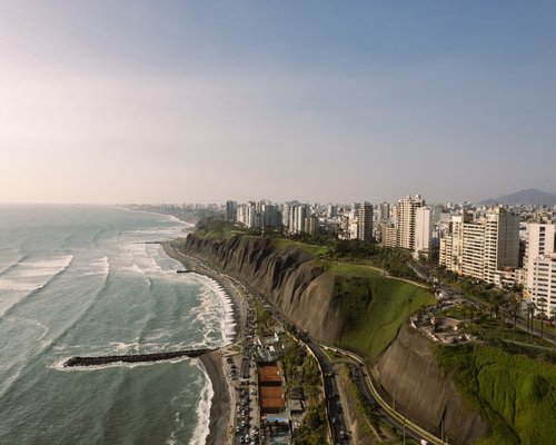 Modern coastal urban area with high rise buildings next to the pacific ocean shore in Lima Peru